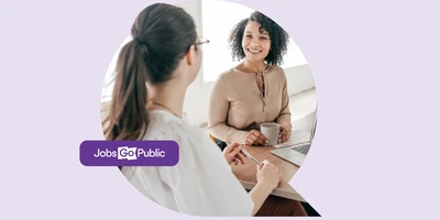Two women are sat at a table in a deep interview discussion